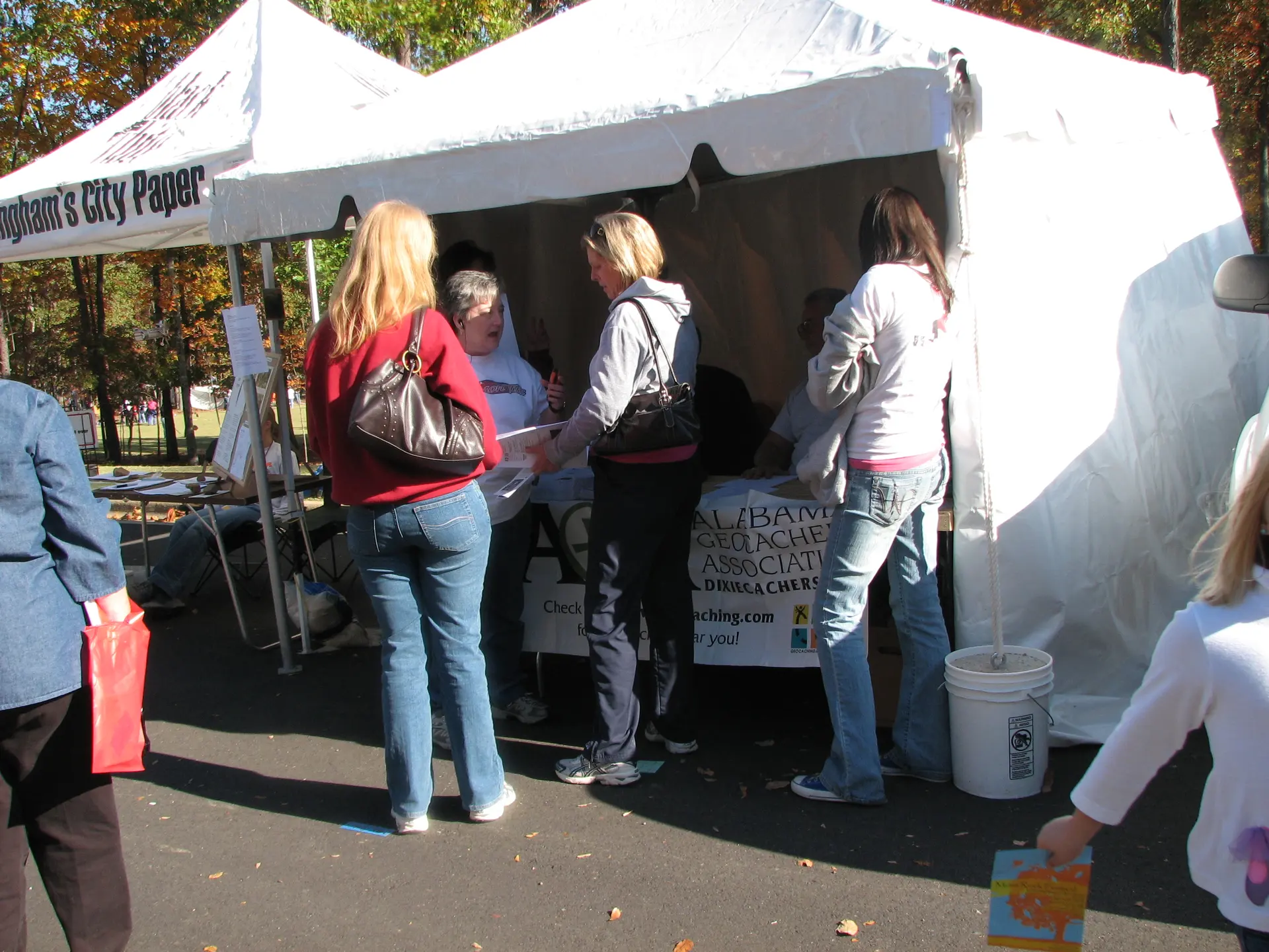 Festivalgoers stop at the Alabama Geocaching Association's tent at the Moss Rock Festival in Hoover.