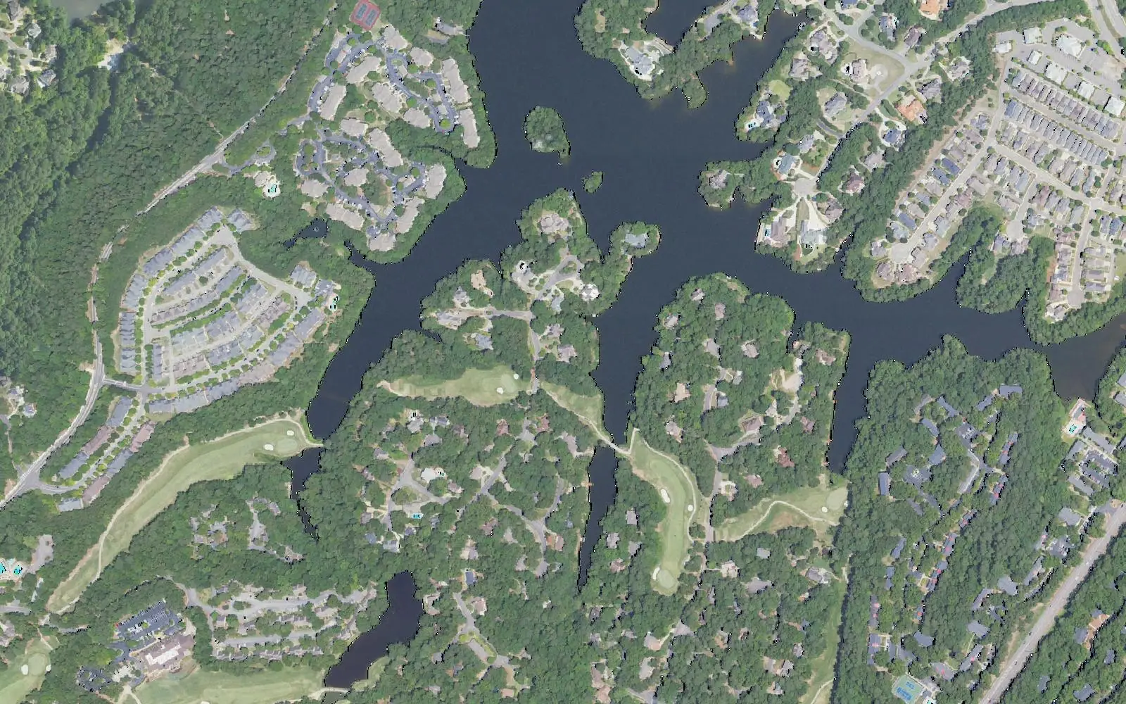Aerial view of homes around a lake and golf fairways in Inverness, in the Shelby County part of Hoover.