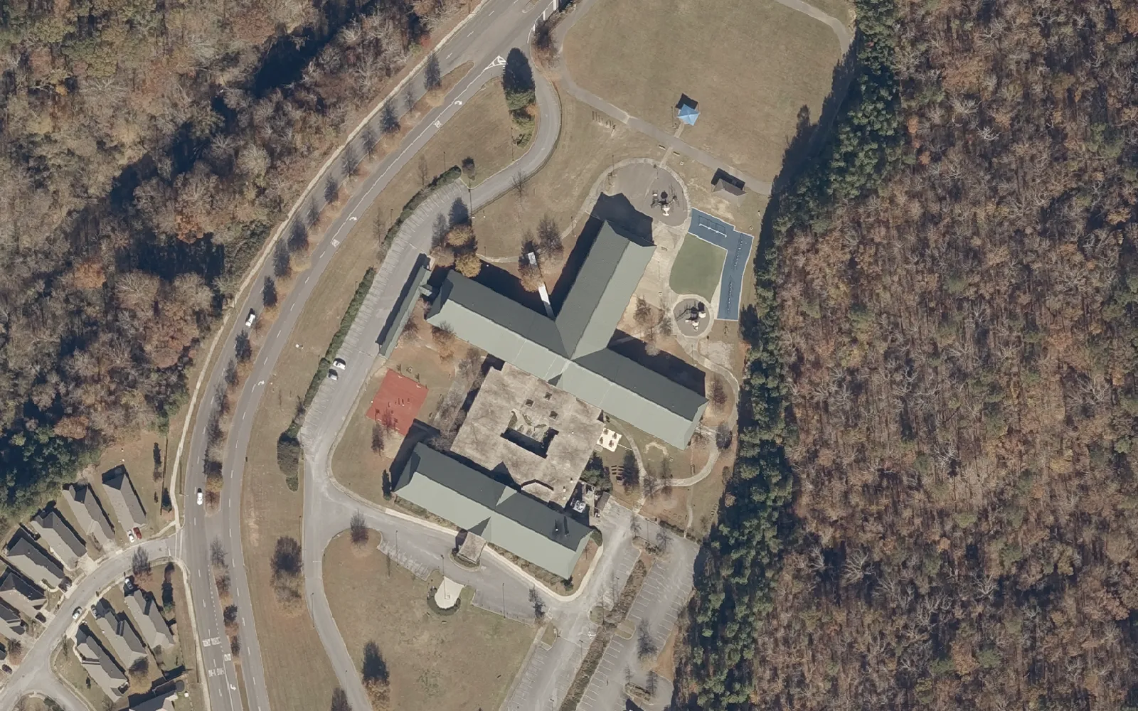 Aerial view of Deer Valley Elementary School on Ross Bridge Parkway in Hoover, with woods on one side and homes on the other.